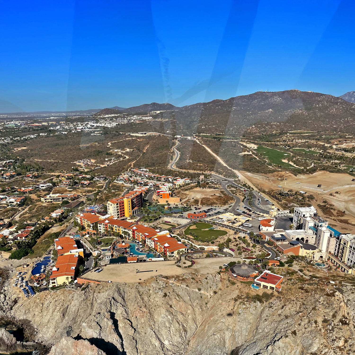 Aerial view of a private helicopter flying over the coast of Baja California Sur